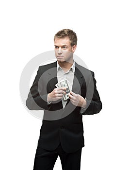 Young successful businessman holding money