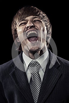 Young successful businessman laughing hard