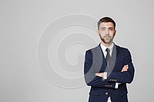Young successful businessman posing over dark background. Isolated White Background. Copy space.
