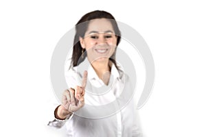 Young successful businesswoman pointing with finger to copy space
