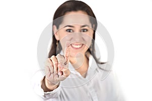 Young successful businesswoman pointing with finger to copy space