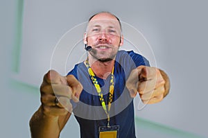 Young successful and confident casual speaker man with headset speaking at corporate business convention coaching at auditorium