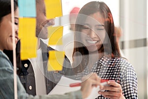 Young successful creative woman and team smile and brainstorm on project at office