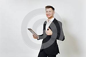 Young successful handsome rich business man in black suit on white background for advertising.
