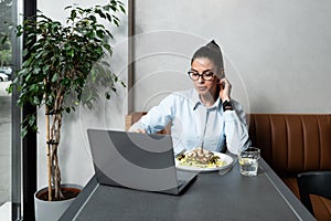 Young successful happy business woman on her lunch break takes the opportunity to have a video call with her boyfriend who works