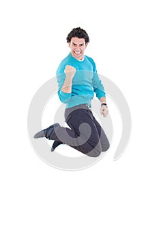 Young successful man jumping out of joy expressing happiness