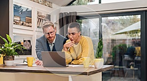 Young successful mixed races couple sitting in living room or kitchen discussing new home project using laptop working and planing