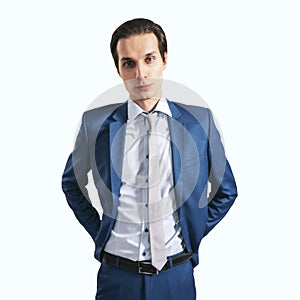 Young successfull businessman in suit and grey tie on light background, close up