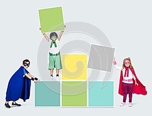 Young superheroes stacking square boards