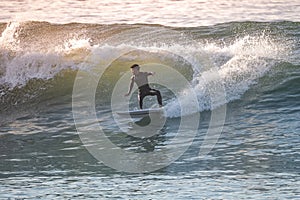 Young surfer enjoying waves