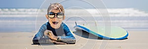 Young surfer, happy young boy at the beach with surfboard BANNER, LONG FORMAT