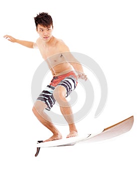 Young surfer practice surfing pose