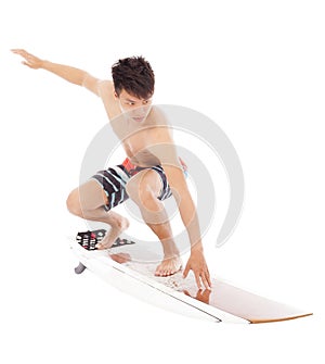 Young surfer practice surfing pose