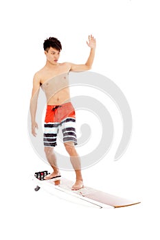 Young surfer practice surfing pose