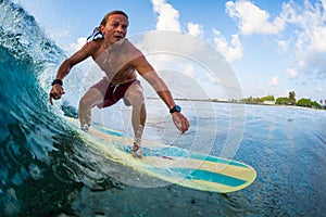 Young surfer rides the wave