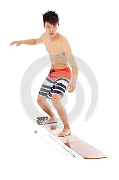 Young surfer simulate surfing pose photo