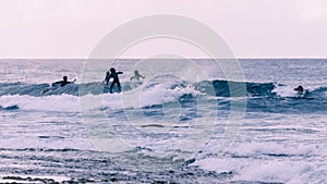 Young surfers takes the waves, vintage style