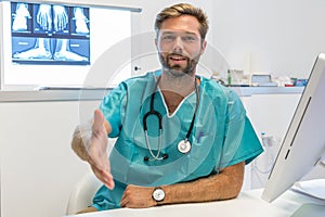 Young surgeon doctor reaches out to us, close up hand