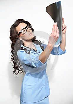 Female doctor looking at an X-ray sheet