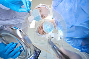 Young surgeon holds forceps with a tooth removed