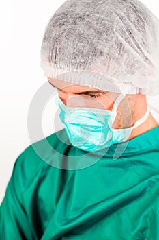 Young surgeon with mask and cap