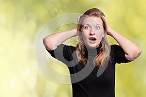 Young surprised girl. Expression emotions. Wow model. Omg woman sale. Hands at head. Studio female mistake photo