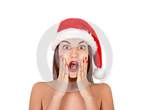 Young surprised girl with open mouth woman in Santa hat and swimsuit. emotional woman in red santa claus hat isolated on white bac