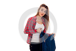 Young surprised student girl with backpack posing isolated on white background in studio