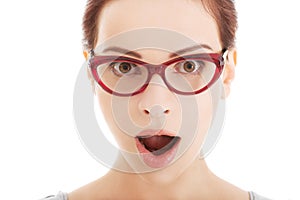 Young surprised woman in eyeglasses.