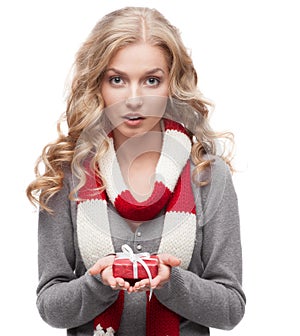 Young surprised woman holding christmas gift