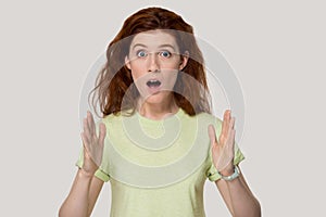 Young surprised woman showing large big size measurement gesture.