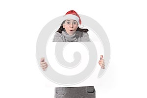 young sweet Latin woman in Santa Christmas hat holding blank billboard