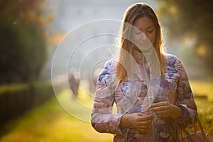 Young sweet woman in love, outdoor backlight. Emotions and femininity. photo