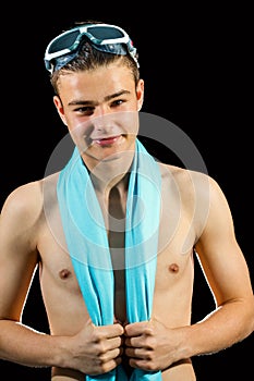 Young swimmer against black background.