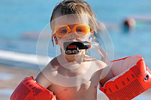 Young swimmer with floats