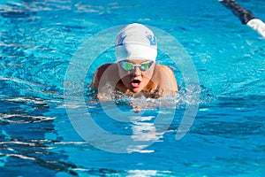 Young swimmer practicing breaststroke.