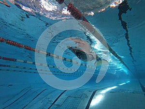 Young swimmer training inside the swimming pool