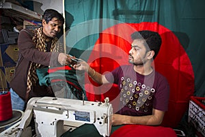 A young tailor Md. Rashed Alam , Age 28 making Bangladeshi national flags at Dhaka, Bangladesh.