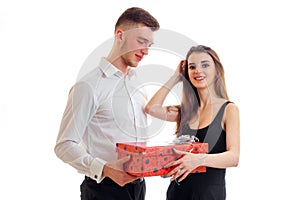 Young tall guy brought a beautiful girl in a red gift box