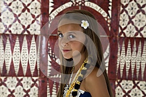 Young tan girl with tapa cloth background photo