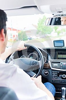 Young Taxi driver driving his car