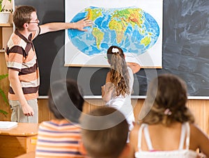 Young teacher at geography lesson photo