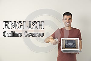 Young teacher with laptop on background. Online English course