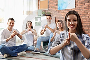 Young teacher showing sign language gesture