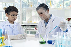 Young teacher and student boy in science class at laboratory