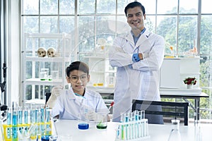 Young teacher and student boy in science class at laboratory