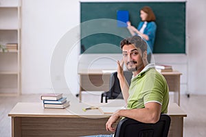 Young teacher and student in the classroom
