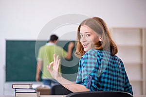 Young teacher and student in the classroom