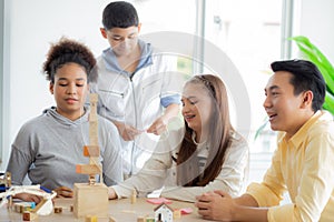 Young teacher and student doing activity playing block wooden for development together with enjoy and fun.