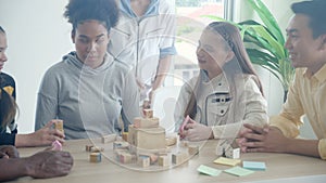 Young teacher and student doing activity playing block wooden for development together with enjoy and fun in the classroom.